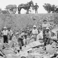 Photo of internees and guards at a road construction